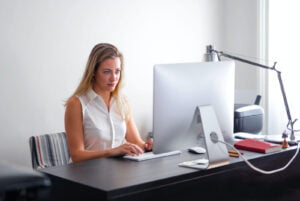 Woman at desk with computer - T-Base Communications